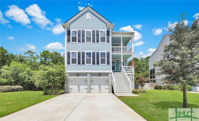 coastal inspired home featuring a garage, a front yard, a balcony, and covered porch