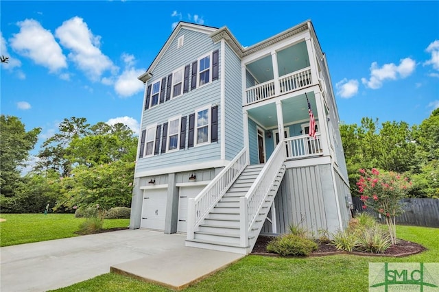 view of front of home with a garage, a balcony, and a front lawn