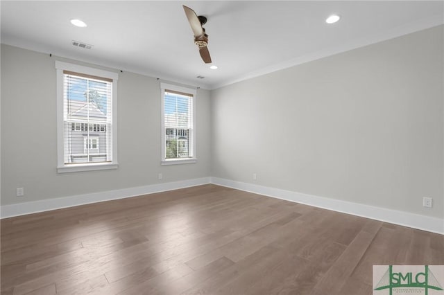 empty room with hardwood / wood-style flooring, ornamental molding, and ceiling fan