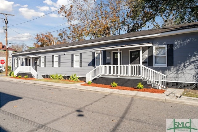 single story home featuring covered porch