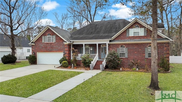 view of front of home with a garage, covered porch, and a front yard