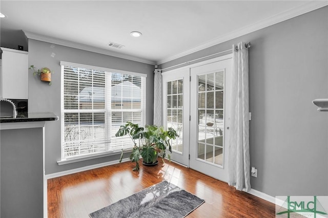 entryway with crown molding, dark hardwood / wood-style floors, and sink