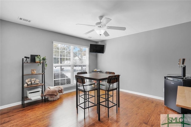 dining room featuring hardwood / wood-style flooring and ceiling fan