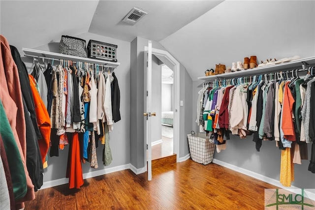 spacious closet featuring lofted ceiling and wood-type flooring