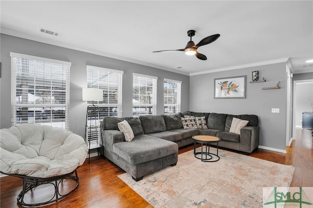 living room with hardwood / wood-style flooring, ornamental molding, and ceiling fan