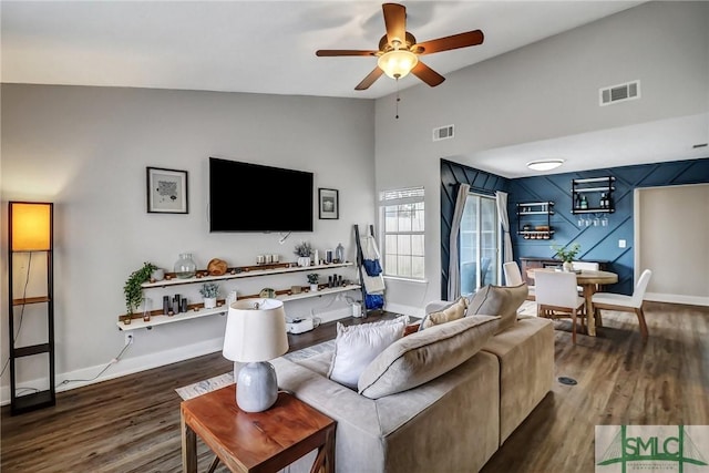 living room with vaulted ceiling, dark hardwood / wood-style floors, and ceiling fan