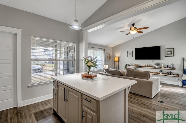 kitchen featuring pendant lighting, ceiling fan, a center island, dark hardwood / wood-style flooring, and vaulted ceiling