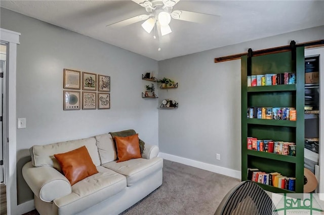 interior space with a barn door, carpet floors, and ceiling fan