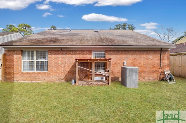 back of house with a lawn and central air condition unit