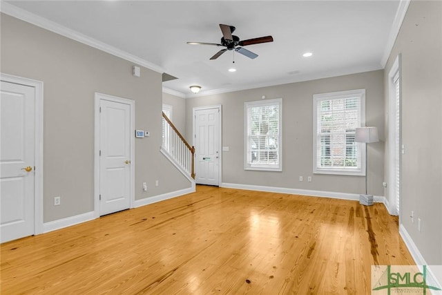 unfurnished living room with wood-type flooring, ornamental molding, and ceiling fan