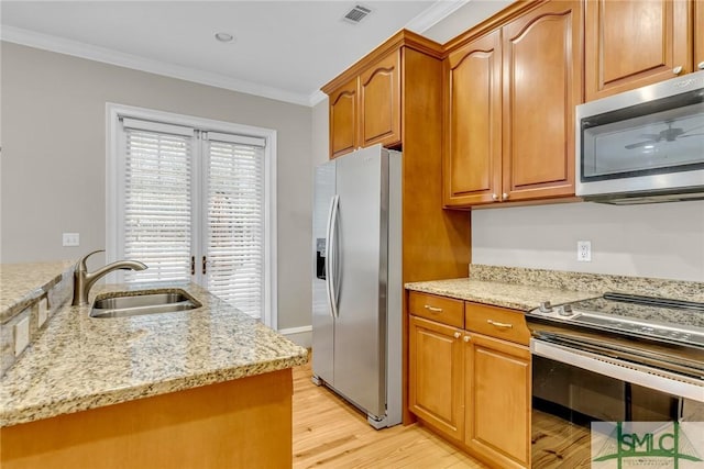 kitchen with appliances with stainless steel finishes, sink, light hardwood / wood-style floors, crown molding, and light stone countertops