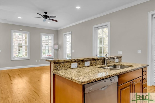 kitchen featuring sink, crown molding, dishwasher, light stone counters, and light wood-type flooring