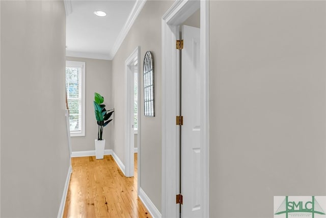 corridor featuring light hardwood / wood-style flooring and ornamental molding