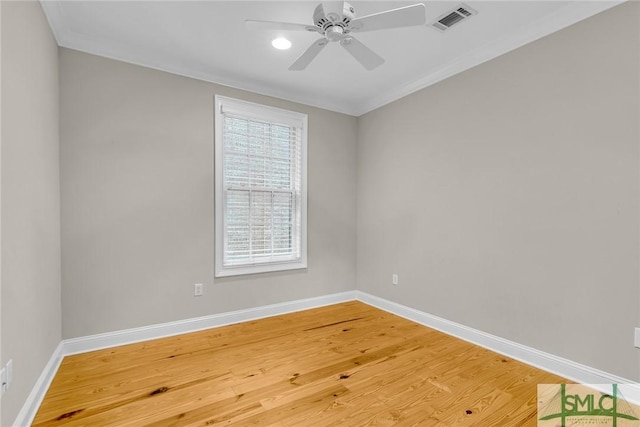 empty room featuring ornamental molding, hardwood / wood-style floors, and ceiling fan