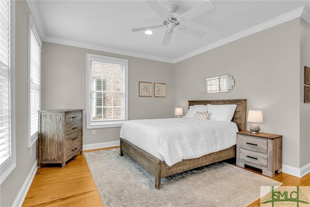 bedroom with ornamental molding, ceiling fan, and light hardwood / wood-style floors