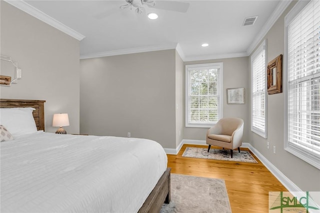 bedroom featuring ornamental molding, hardwood / wood-style floors, and ceiling fan