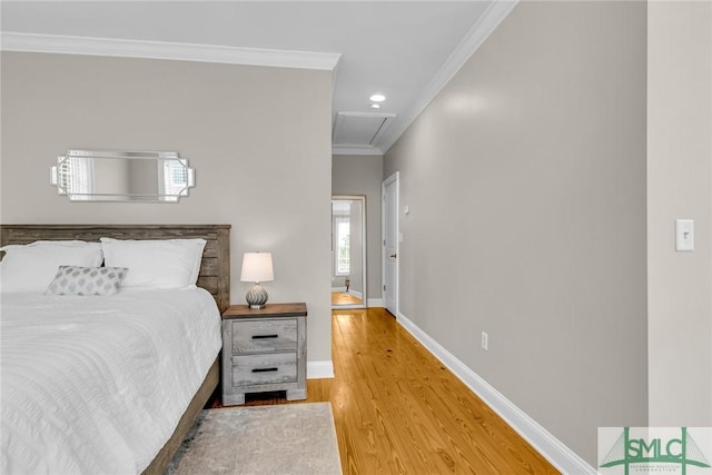 bedroom with crown molding and hardwood / wood-style flooring