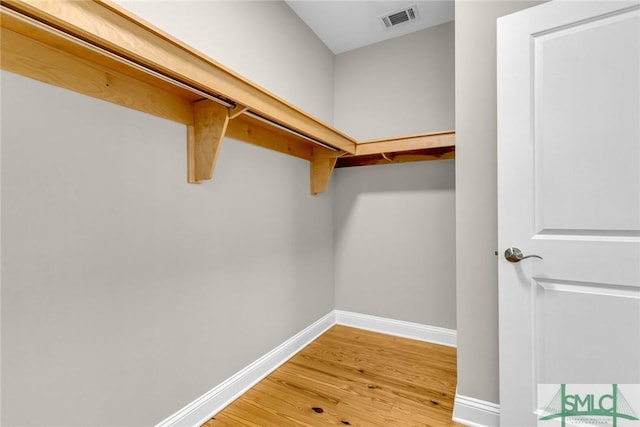 spacious closet with hardwood / wood-style flooring