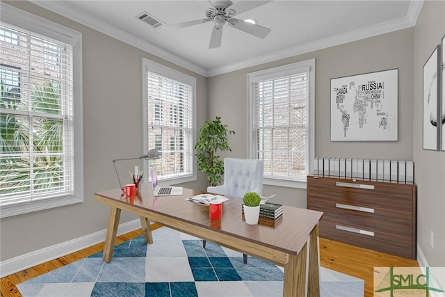 home office featuring ornamental molding, plenty of natural light, and light wood-type flooring