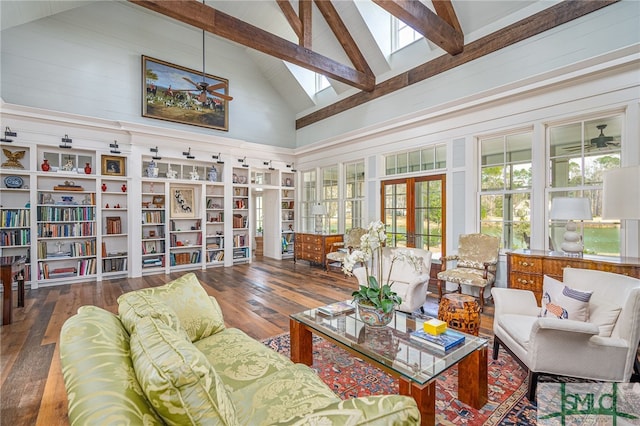 interior space featuring a skylight, a ceiling fan, wood-type flooring, french doors, and beam ceiling