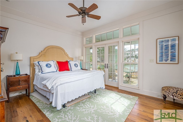 bedroom with wood finished floors, a ceiling fan, baseboards, access to exterior, and french doors