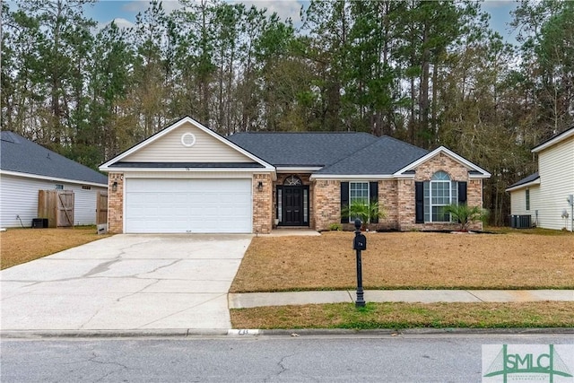 ranch-style home featuring a garage, central AC unit, and a front yard