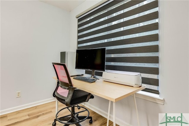 home office with hardwood / wood-style flooring