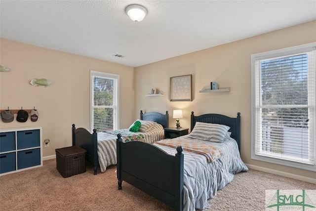 carpeted bedroom featuring a textured ceiling