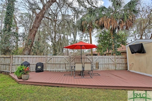 wooden terrace featuring a yard