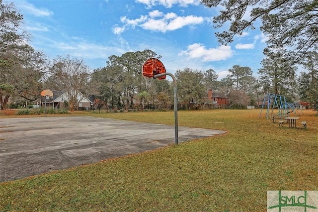 view of sport court featuring a yard and a playground