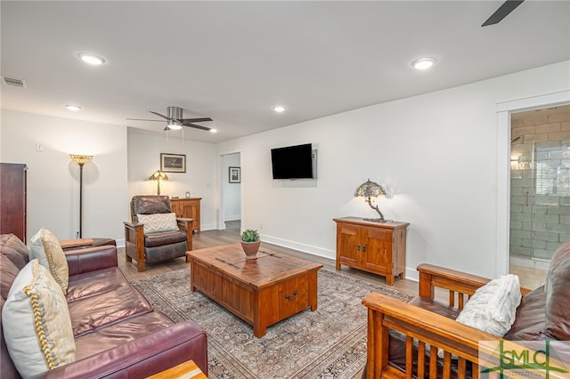 living room with ceiling fan and light wood-type flooring