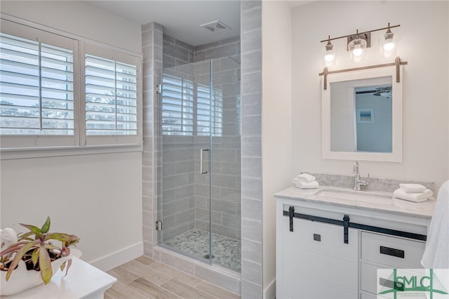 bathroom with vanity and a shower with shower door