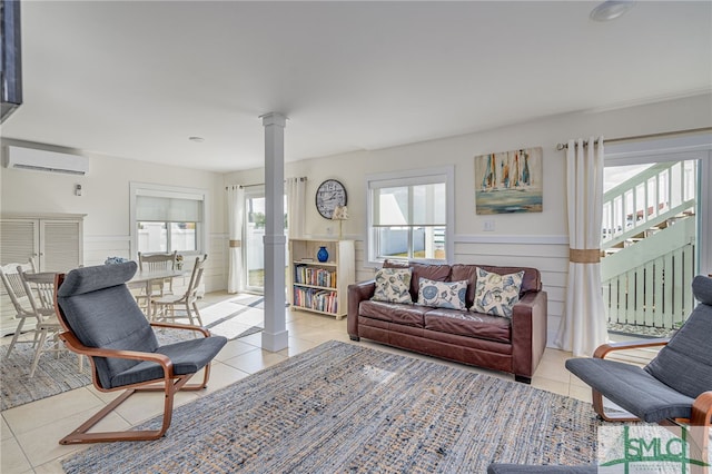 tiled living room with decorative columns and a wall mounted air conditioner