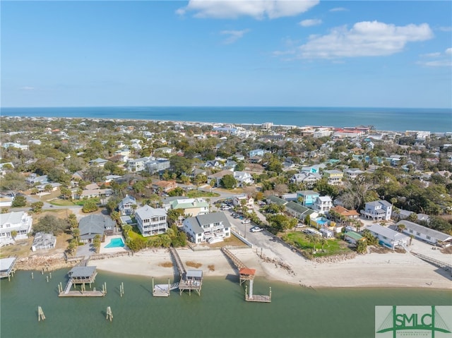 drone / aerial view featuring a beach view and a water view