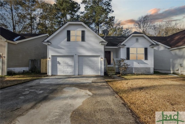 front of property featuring a garage and a lawn