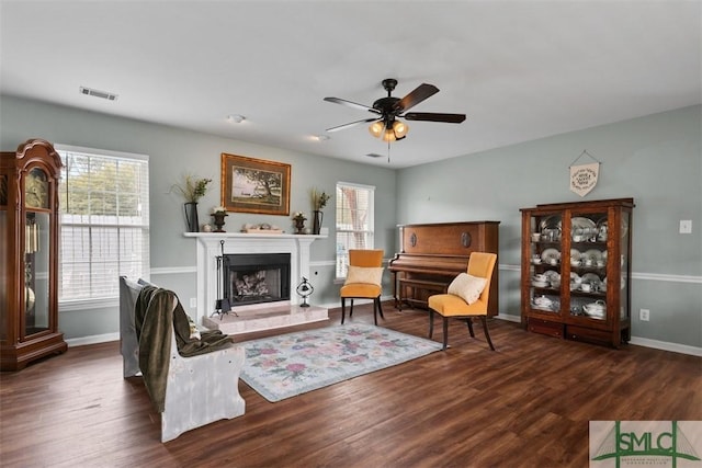 living room featuring dark hardwood / wood-style flooring, plenty of natural light, and ceiling fan