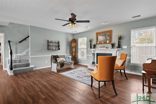 living area featuring hardwood / wood-style flooring and ceiling fan