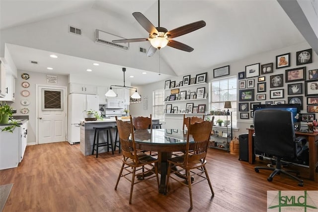 dining space with ceiling fan, wood-type flooring, and high vaulted ceiling