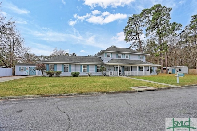 view of front facade featuring a front yard and covered porch