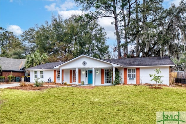 ranch-style house with covered porch and a front lawn