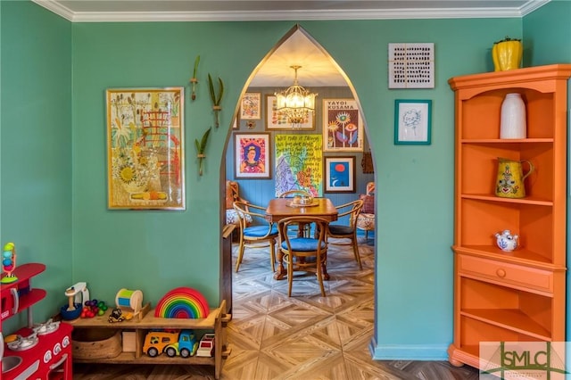 playroom featuring ornamental molding, parquet flooring, and a notable chandelier