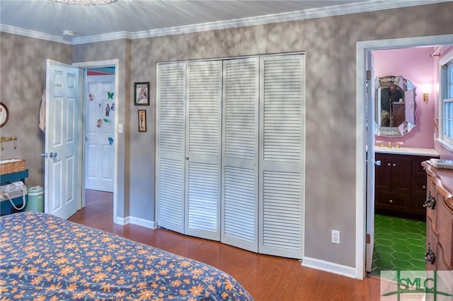 bedroom featuring crown molding, wood-type flooring, connected bathroom, and a closet