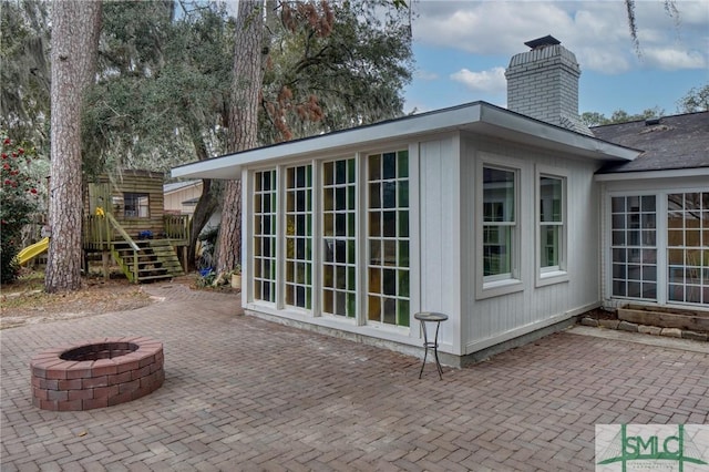 view of outbuilding with a fire pit