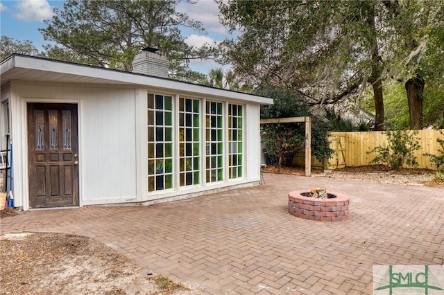 view of outbuilding with an outdoor fire pit