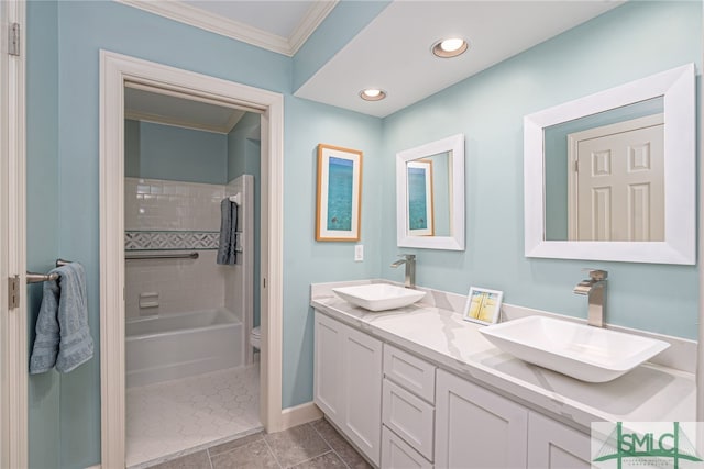 full bathroom with tiled shower / bath combo, ornamental molding, vanity, toilet, and tile patterned floors