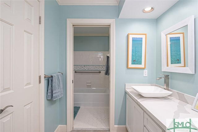 bathroom with crown molding, tiled shower / bath, vanity, and tile patterned flooring