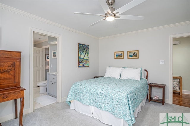 bedroom with crown molding, ceiling fan, connected bathroom, and light carpet