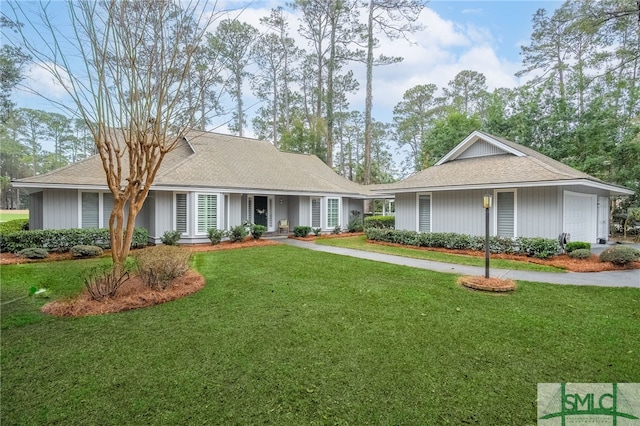 single story home with a garage and a front lawn