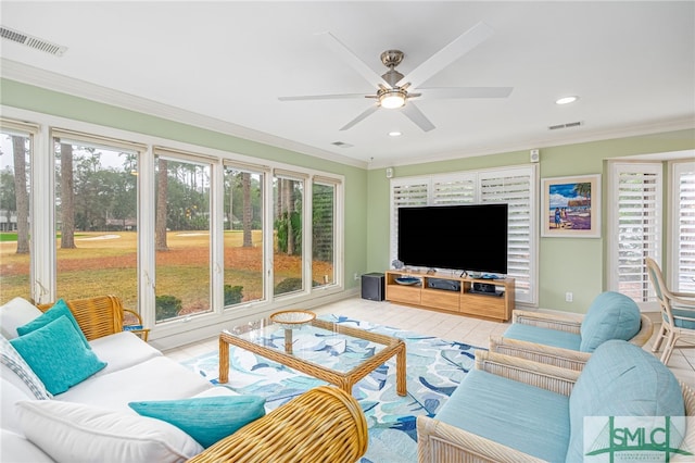 living room with ceiling fan and ornamental molding