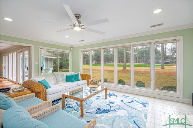 sunroom / solarium featuring ceiling fan